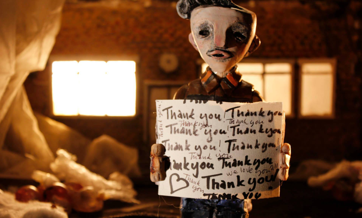 The Dream Machine characters and holding a leaf